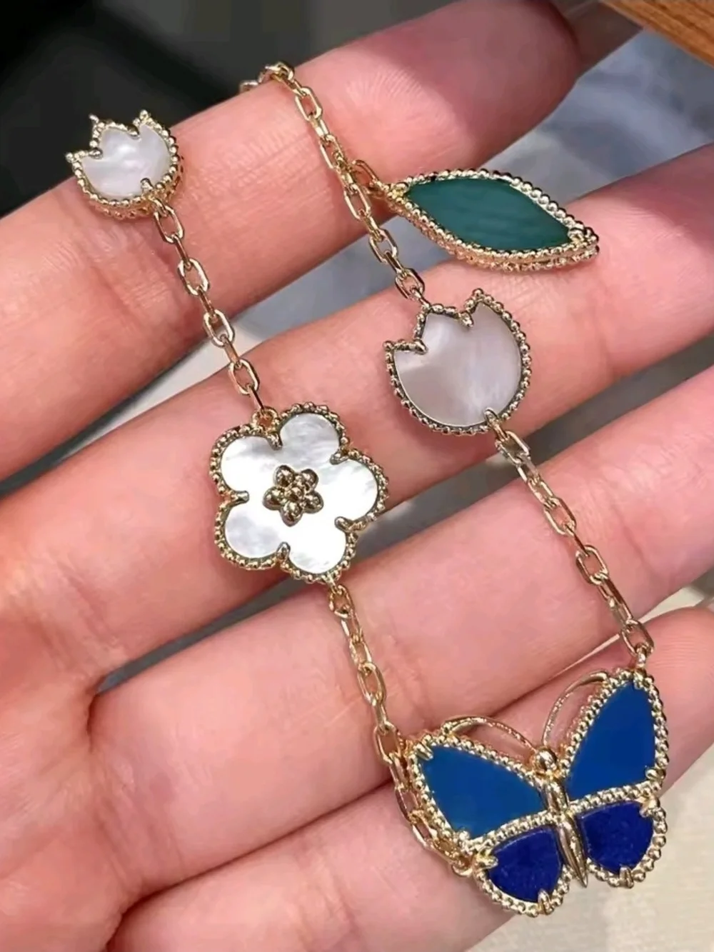 Gold Charm Bracelet with Blue Butterfly and Mother-of-Pearl Accents